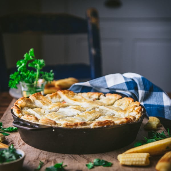 Square side shot of an old fashioned chicken pot pie recipe on a wooden table