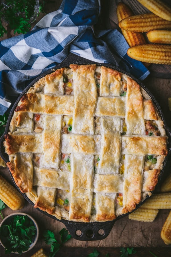 Classic chicken pot pie in a cast iron skillet with a lattice top pie crust