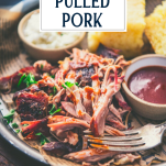 Close up side shot of the best pulled pork recipe on a plate with text title overlay