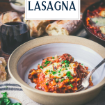 Side shot of easy skillet lasagna in a bowl with text title overlay
