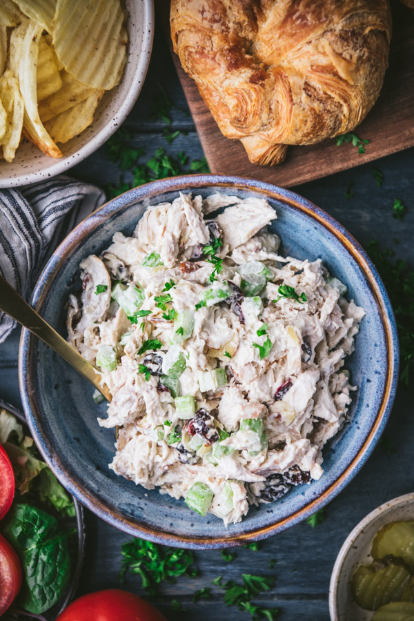 Close overhead shot of southern chicken salad recipe served in a blue ceramic bowl.