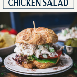 Side shot of a chicken salad sandwich on a plate with a text title box at the top