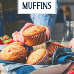 Hands picking up a strawberry muffin with text title overlay