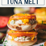 Stacked tuna melt sandwich with text title box at top
