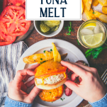 Overhead shot of hands eating a tuna melt recipe with text title overlay
