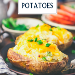 Side shot of the best twice baked potato recipe served on a table with a ham and salad and text title overlay