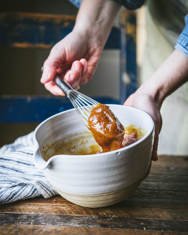 Whisking together a ham glaze with apricot jam