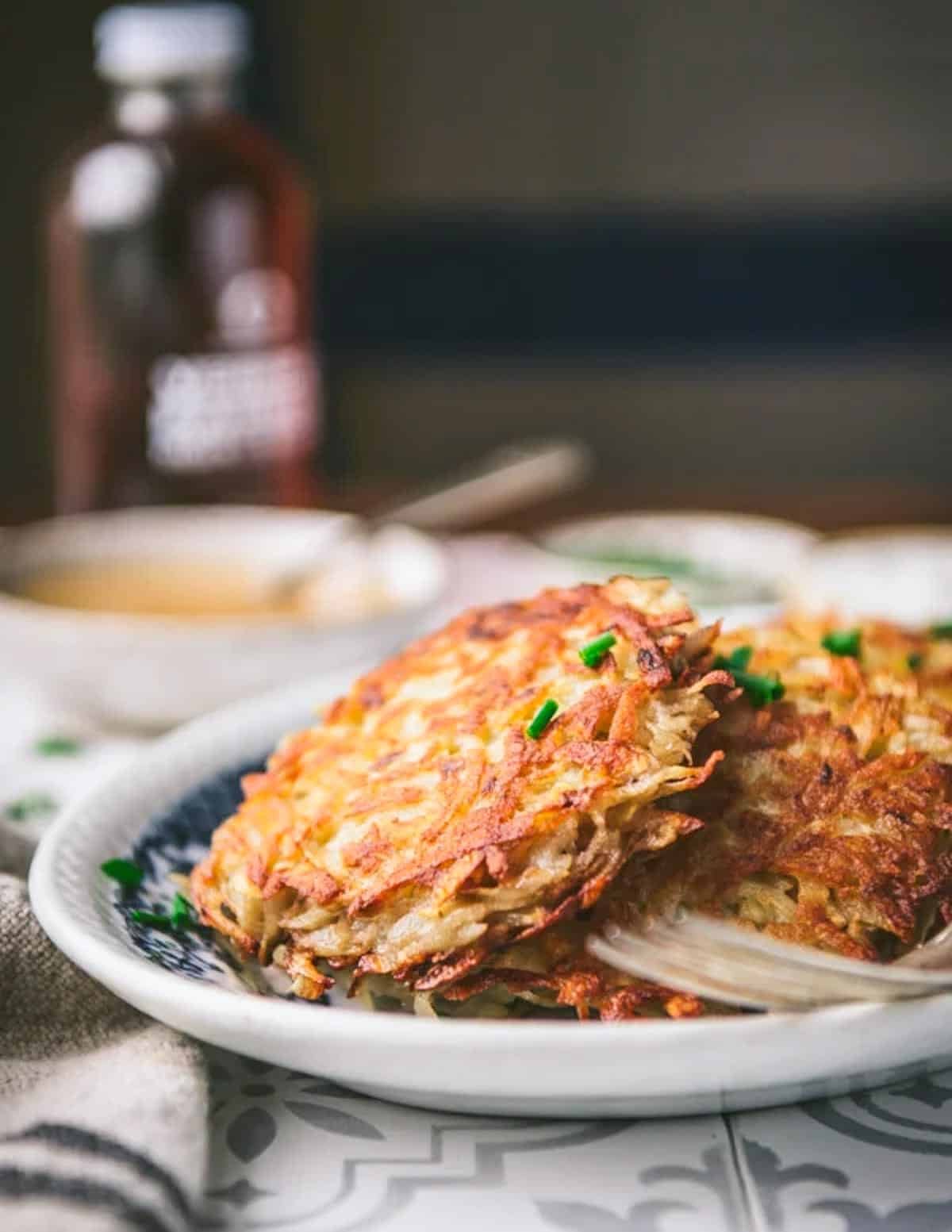 An easy potato pancakes recipes served on a blue and white tray.