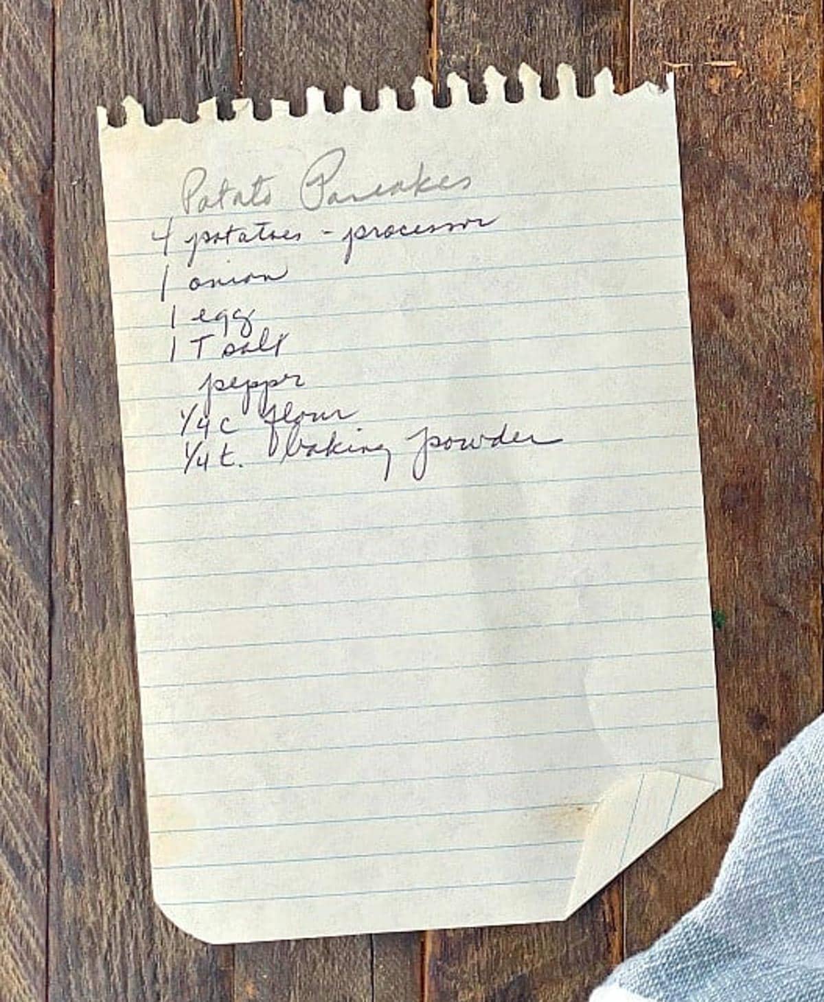 Great grandmother's potato pancake recipe handwritten on a sheet of paper.