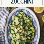 Overhead shot of the best sauteed zucchini recipe on a blue and white plate with text title box at top