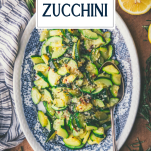 Overhead shot of a plate of sauteed zucchini with text title overlay