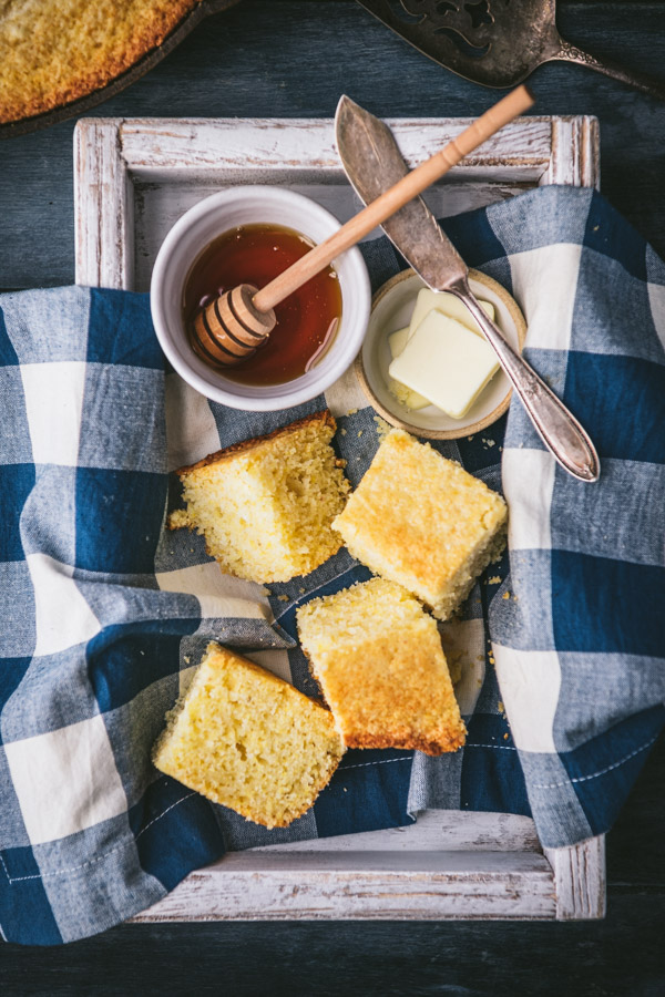 White wooden tray full of squares of sweet cornbread