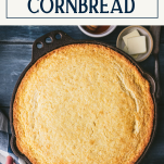 Overhead shot of sweet cornbread in a cast iron skillet with text title box at top