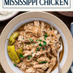 Close overhead shot of a bowl of crock pot mississippi chicken with text title box at top