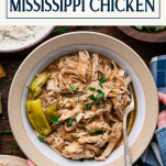 Hands serving a bowl of the best mississippi chicken recipe with text title box at top