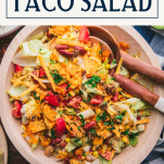 Close overhead image of taco salad with doritos and text title box at top