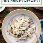 Fork in a white bowl of chicken mushroom casserole with text title box at top