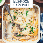 Overhead image of a white baking dish full of chicken mushroom casserole with text title overlay