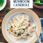 Overhead shot of a bowl of chicken mushroom casserole with a side salad and text title overlay