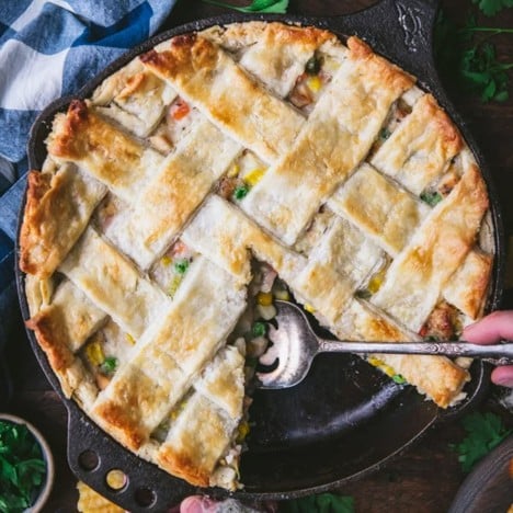 Square featured image of homemade chicken pot pie in a skillet