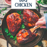 Basting oven bbq chicken in a pan with text title overlay