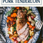 Close overhead image of roasted pork tenderloin recipe with vegetables and text title box at top