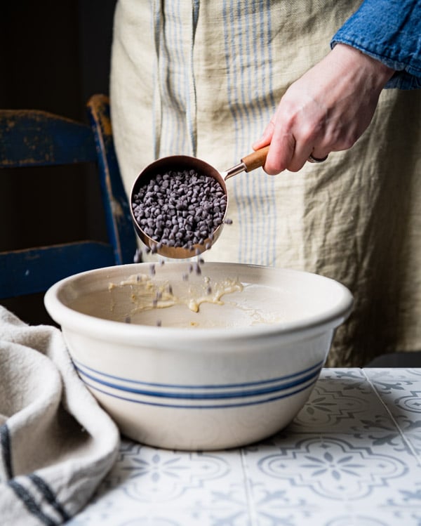 Adding chocolate chips to a bowl