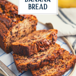 Sliced loaf of chocolate chip banana bread on a platter with text title overlay