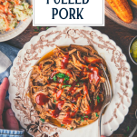 Overhead shot of a bowl of slow cooker pulled pork with text title overlay