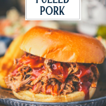 Close up side shot of a crock pot pulled pork sandwich with text title overlay