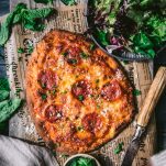Overhead shot of flatbread pepperoni pizza on a cutting board