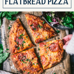 Overhead shot of hand picking up a slice of flatbread pizza with text title box at top