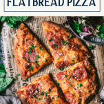 Overhead shot of sliced flatbread pizza with text title box at top