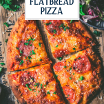 Close overhead shot of sliced flatbread pizza with text title overlay
