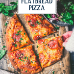 Hand picking up sliced flatbread pizza with text title overlay