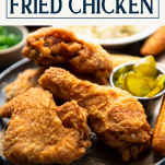 Close up side shot of a plate of fried chicken recipe with text title box at top