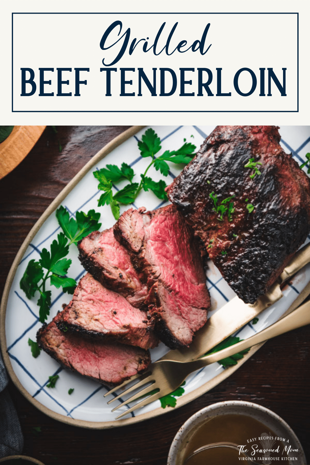 Sliced grilled beef tenderloin on a plate with text title box at top