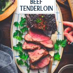 Overhead shot of sliced beef tenderloin on a plate with text title overlay