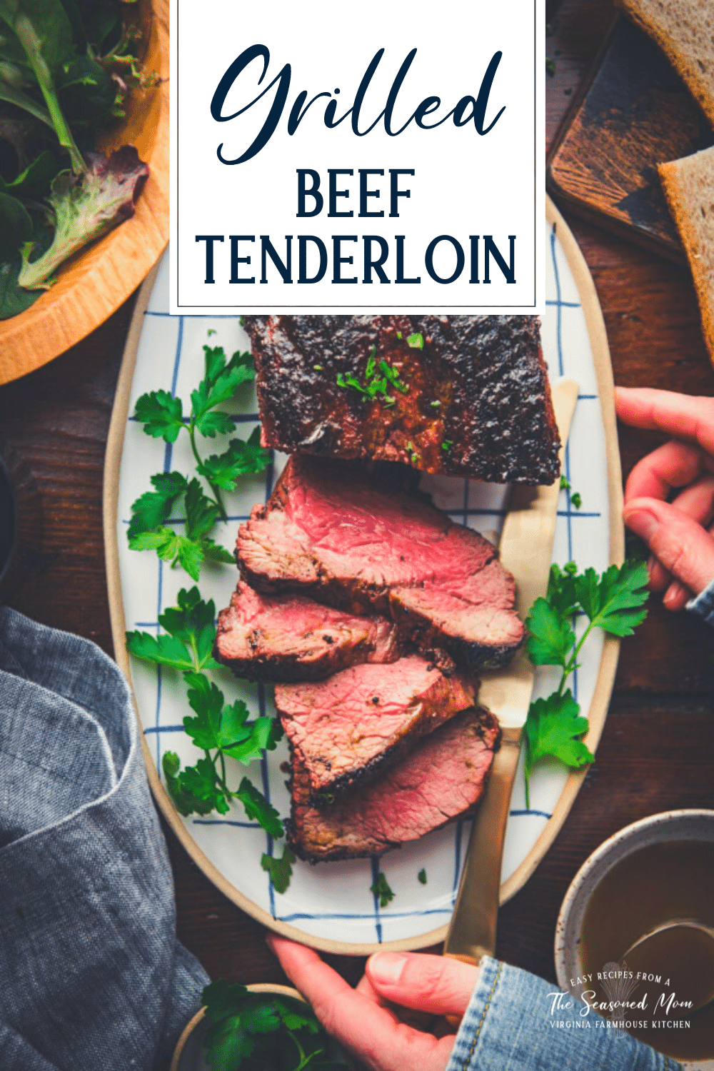 Overhead shot of sliced beef tenderloin on a plate with text title overlay