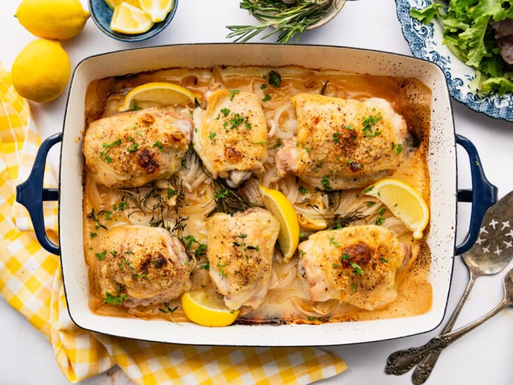 Lemon roasted chicken in a baking dish.