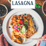Overhead image of a white plate of the best mexican lasagna recipe with text title overlay