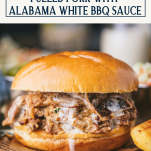 Close up side shot of crock pot pulled pork sandwich with alabama white bbq sauce and text title box at top
