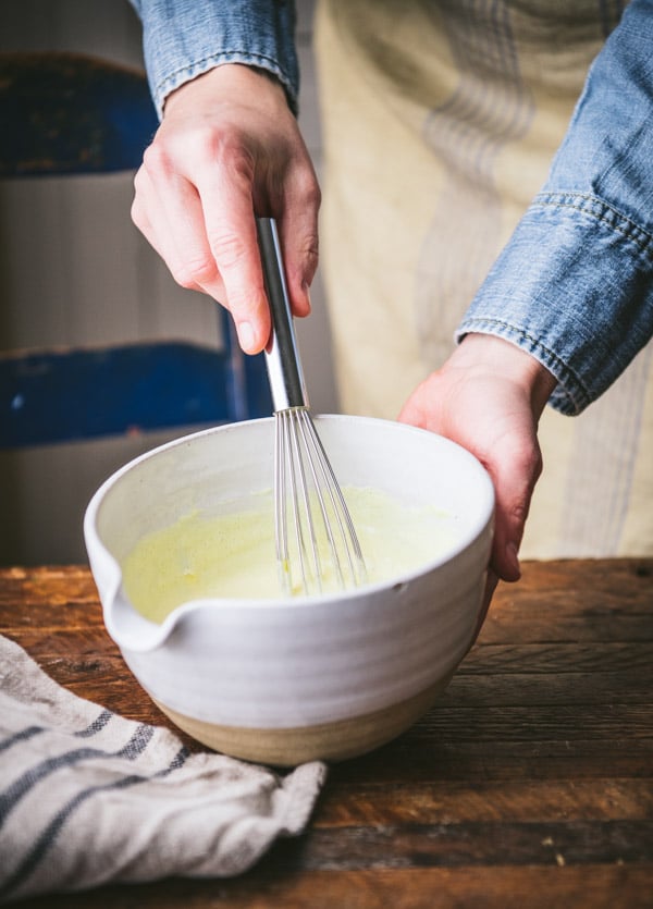 Whisking together mayonnaise dressing in a small bowl