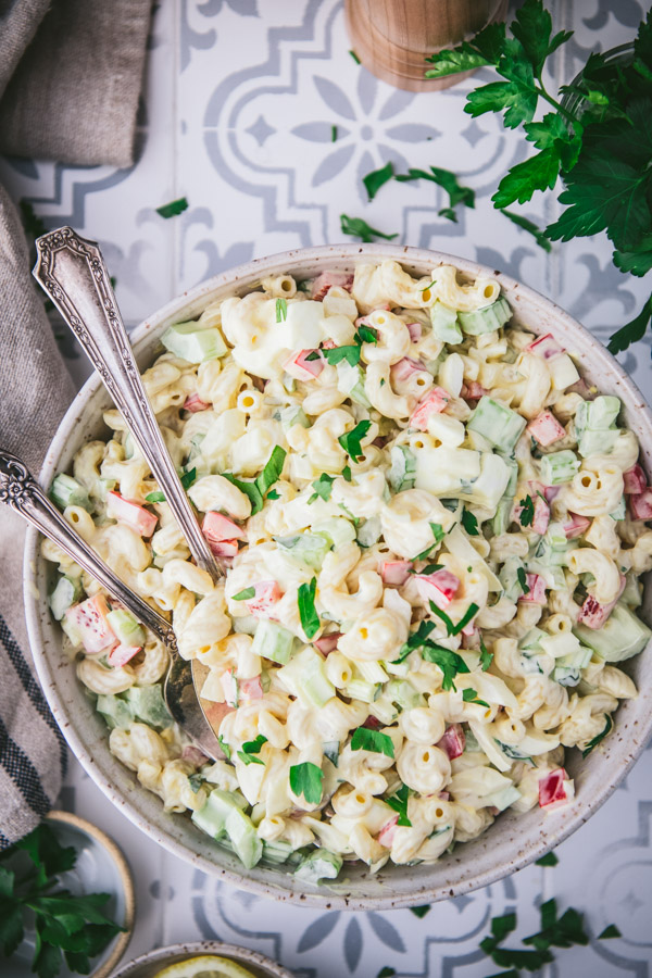 Close overhead shot of the best macaroni salad recipe served on a vintage tile table