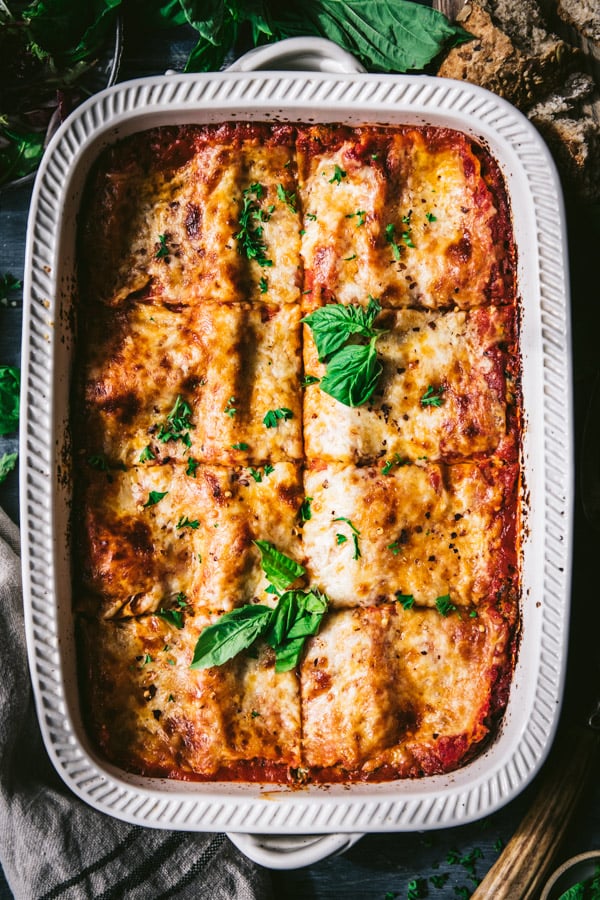 Close overhead shot of spinach lasagna in a white dish