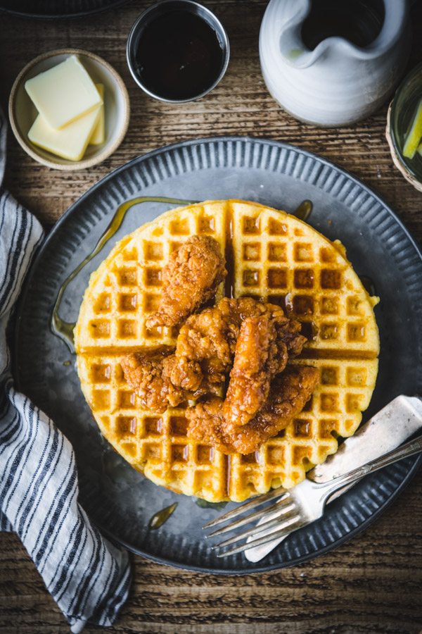 Overhead shot of a metal plate of the best chicken and waffles recipe.