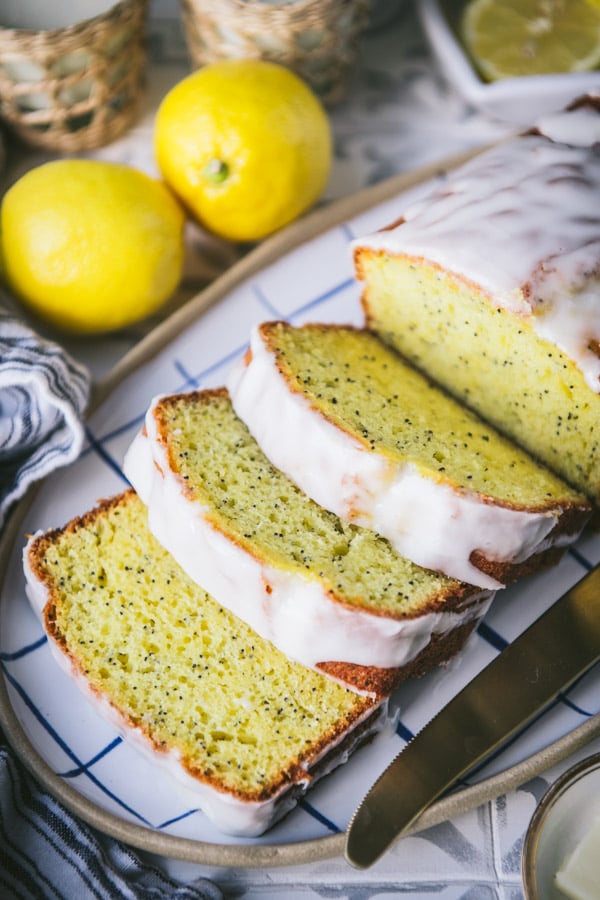 Close up shot of a sliced loaf of lemon poppy seed bread on a tray