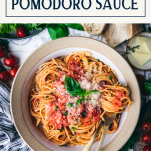 Overhead shot of a bowl of pomodoro sauce with text title box at top