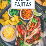 Serving platter of steak fajitas with text title overlay