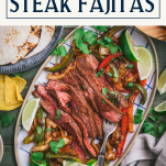 Platter of sheet pan steak fajitas with text title box at top